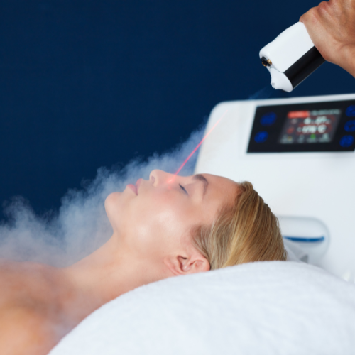 Woman laying on bed receiving targeted cryotherapy on face
