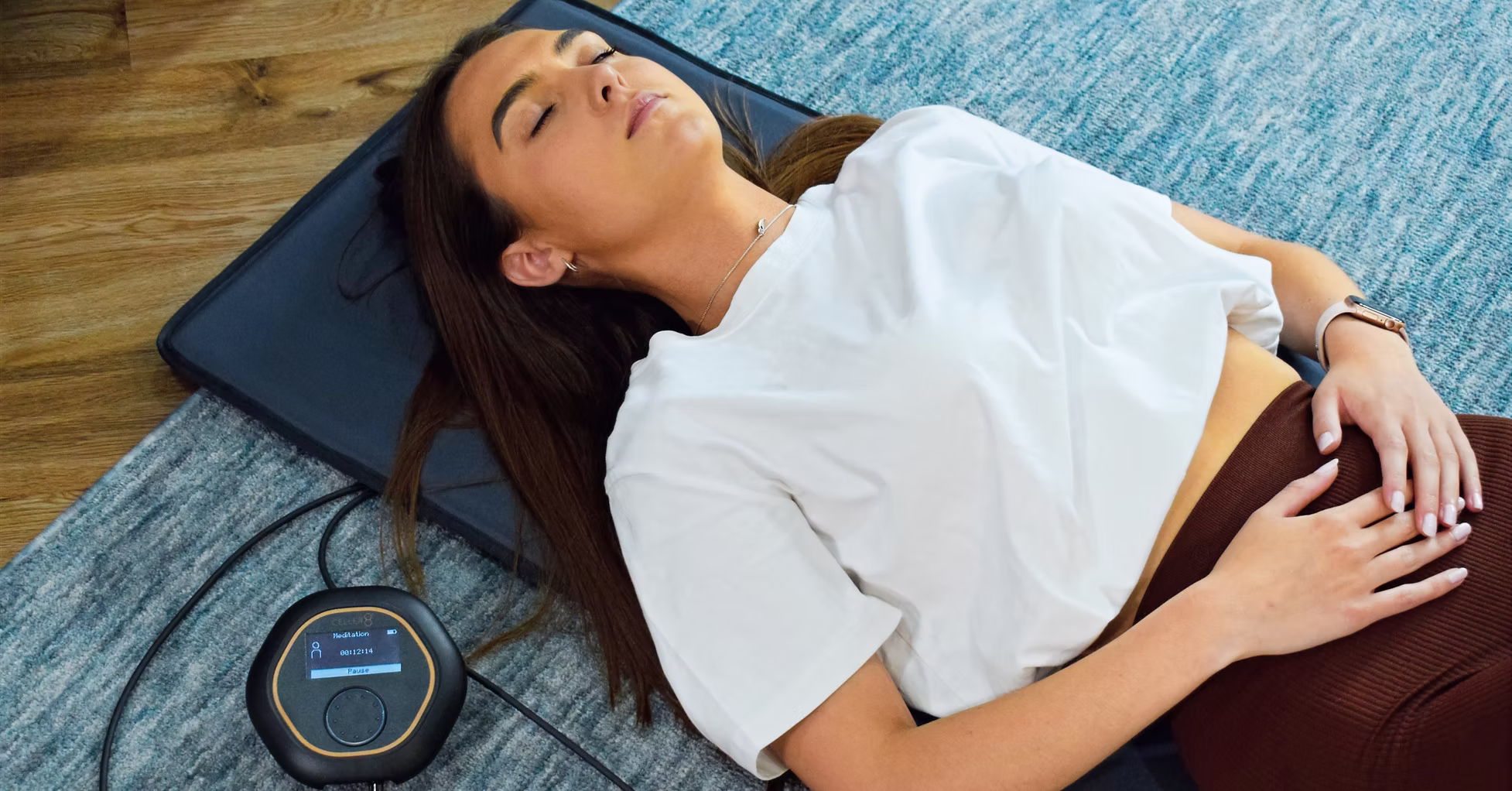 Woman laying on PEMF Mat